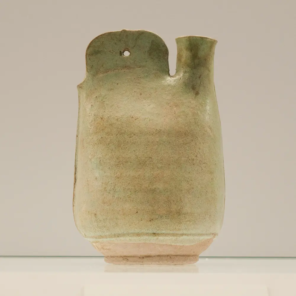 Full frontal view of a 1000-year-old Liao Dynasty green-glazed pottery cockscomb leather flask