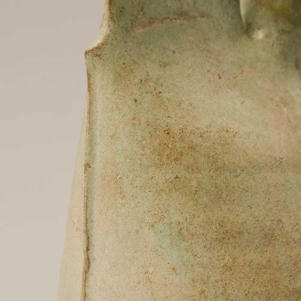 Close-up of the vertical mold seam on the side of a Liao Dynasty leather-form pottery flask